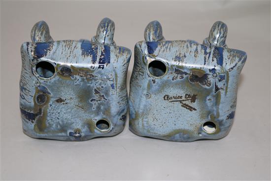 A pair of Clarice Cliff golly blue mottle glazed bookends, height 15.5cm, one damaged
